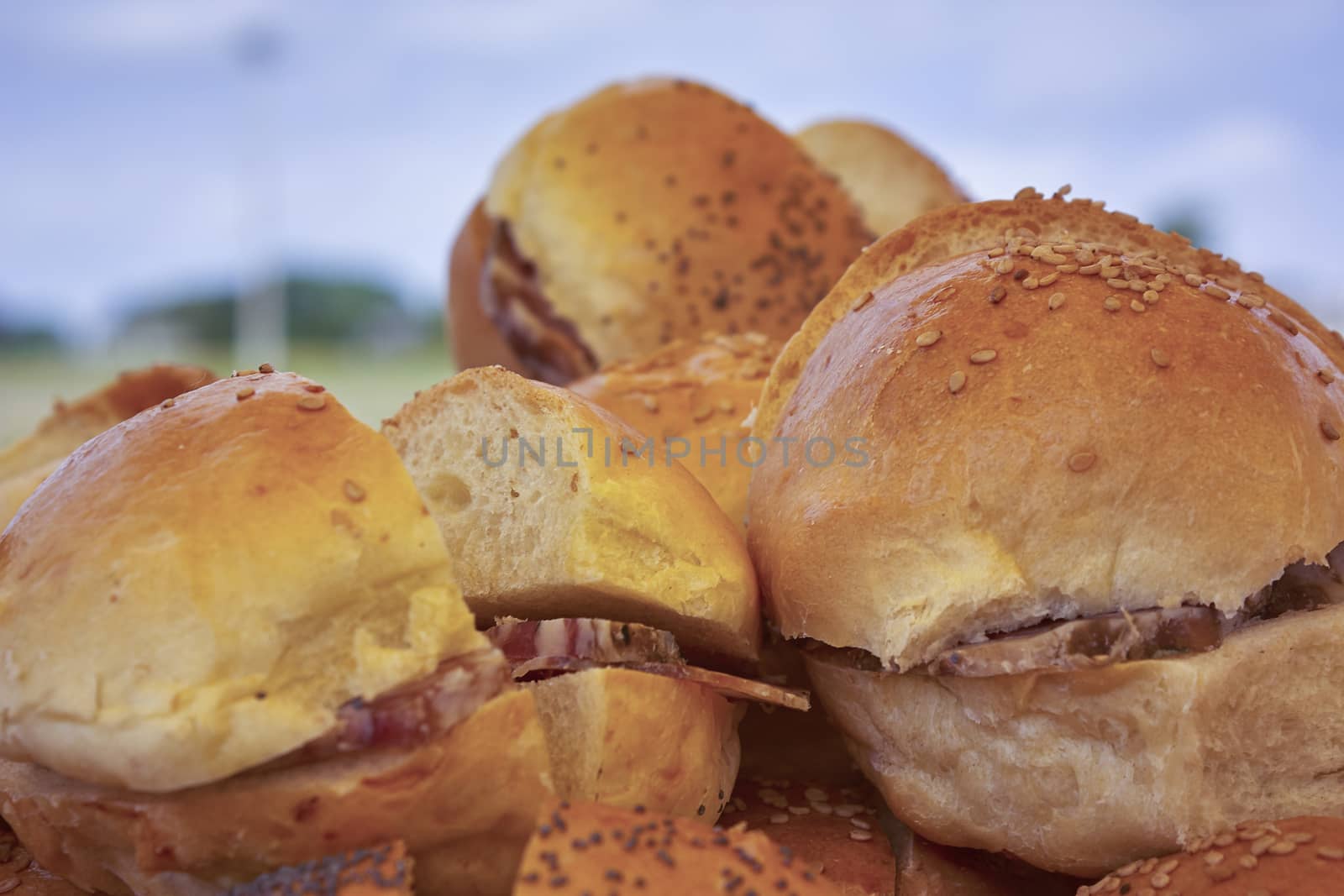 Detail of some sandwiches stuffed with pork on an outdoor dining.