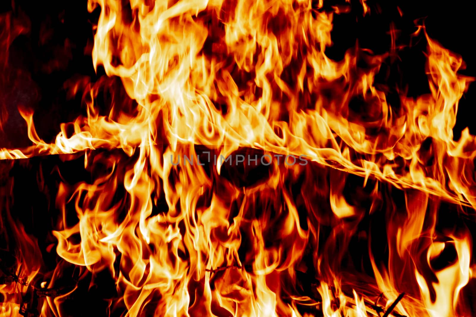 Wood fire on black background.Fire on a dark background. Background from fire. Fire close up. Background for designers.