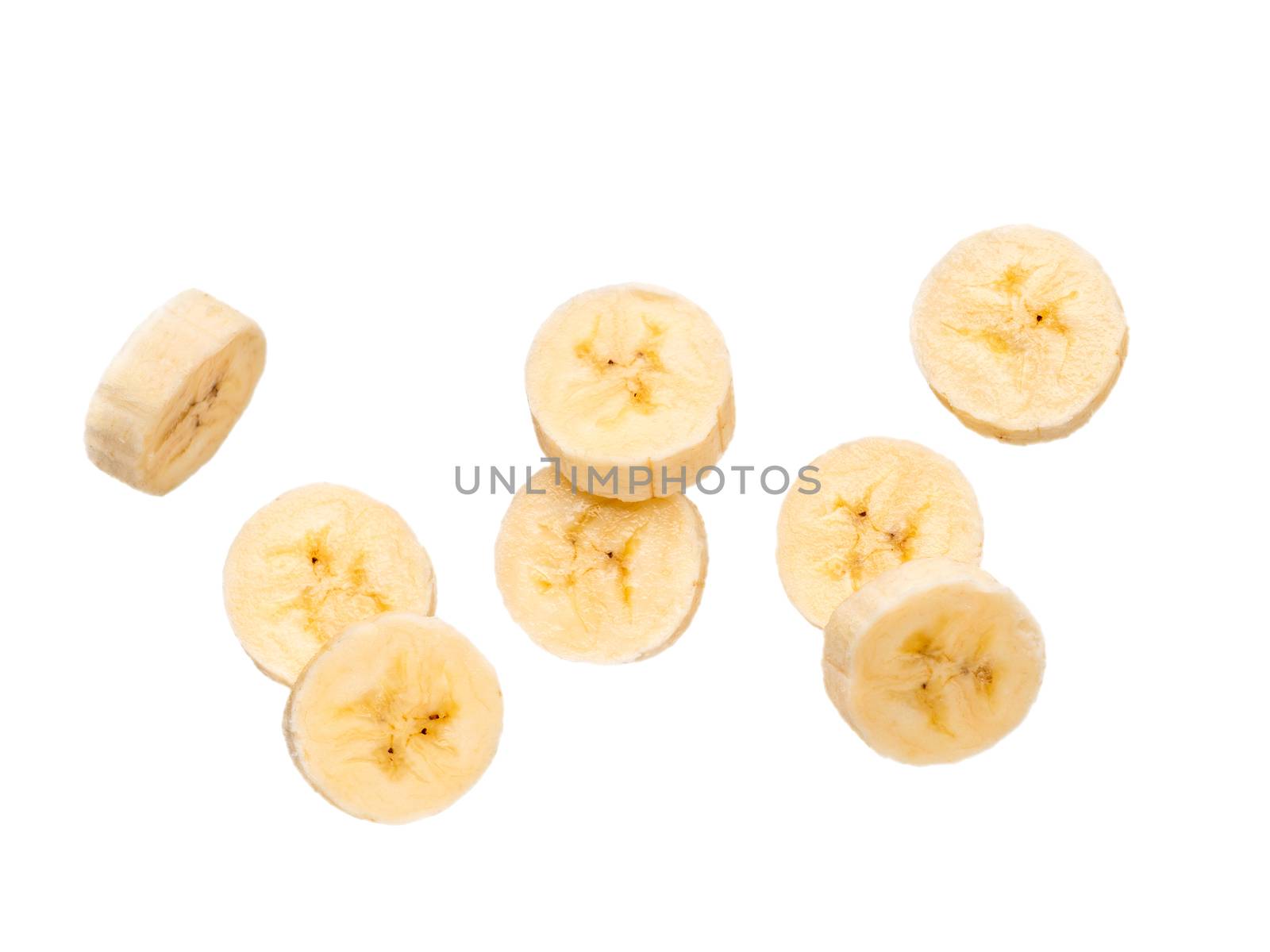 Many banana slices falling, isolated on white background with clipping path. Studio shoot.