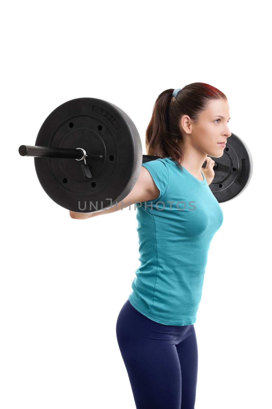 Beautiful fit young girl with barbell on her shoulders getting ready to do squats, isolated on white background.

