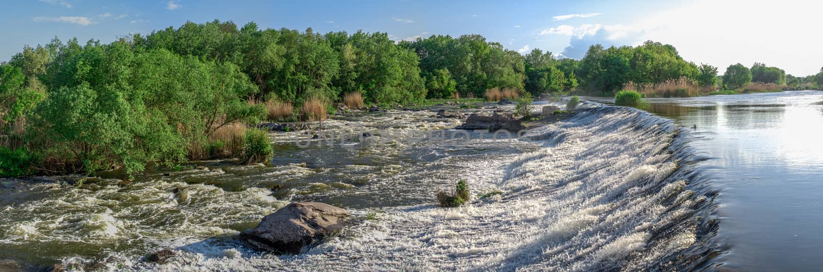 Power station dam on the Southern Bug River near the village of Migiya, Ukraine, on a sunny summer day