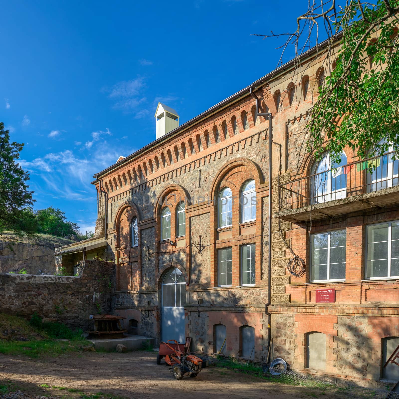 Old hydroelectric station on the Southern Bug River near the village of Migiya, Ukraine, on a sunny summer day