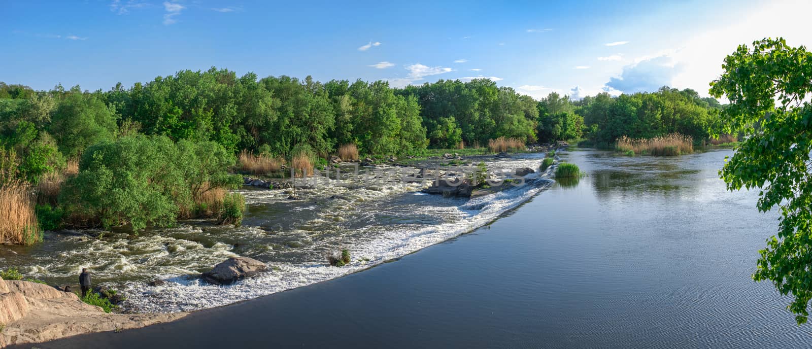 Power station dam on the Southern Bug River near the village of Migiya, Ukraine, on a sunny summer day