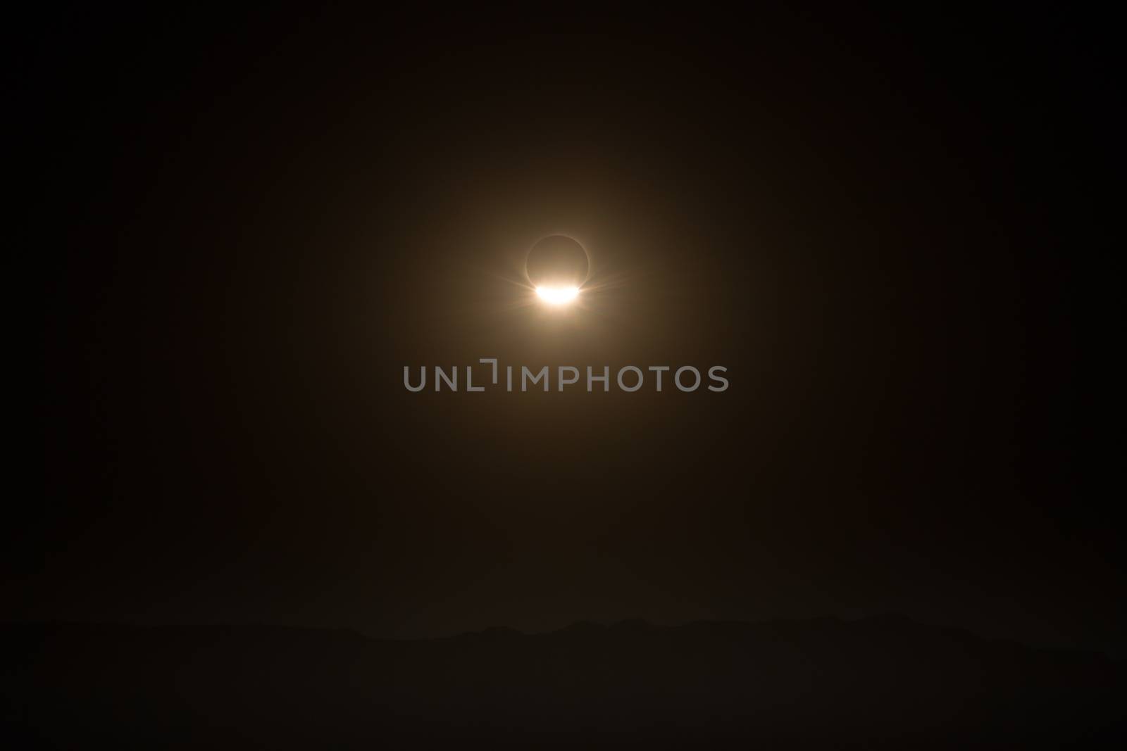 landscape with total eclipse of so, over the mountains