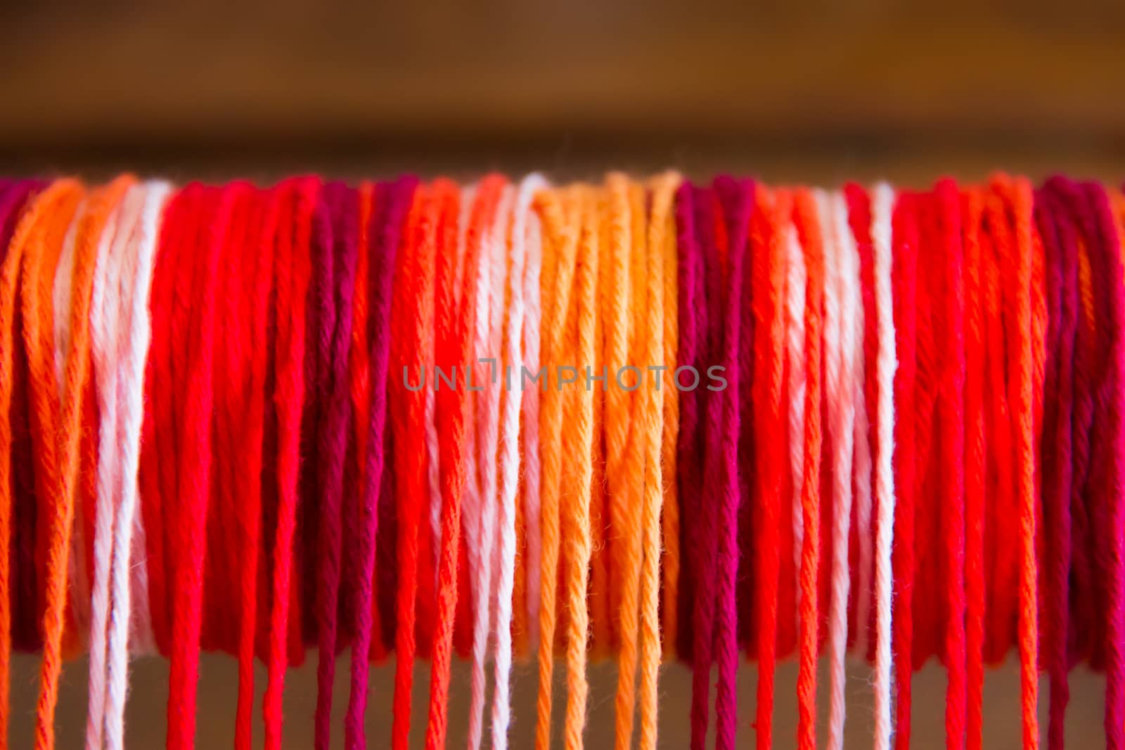 textured background of colored yarn on the loom by GabrielaBertolini