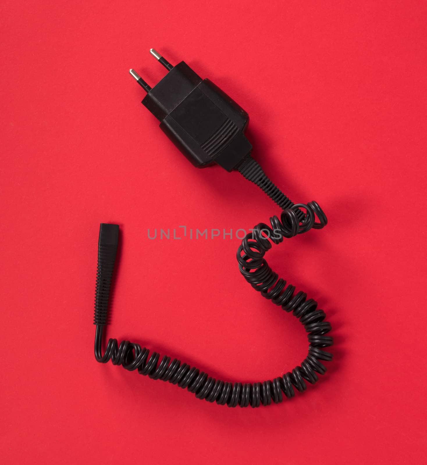 Black charger (220v) isolated on a red background