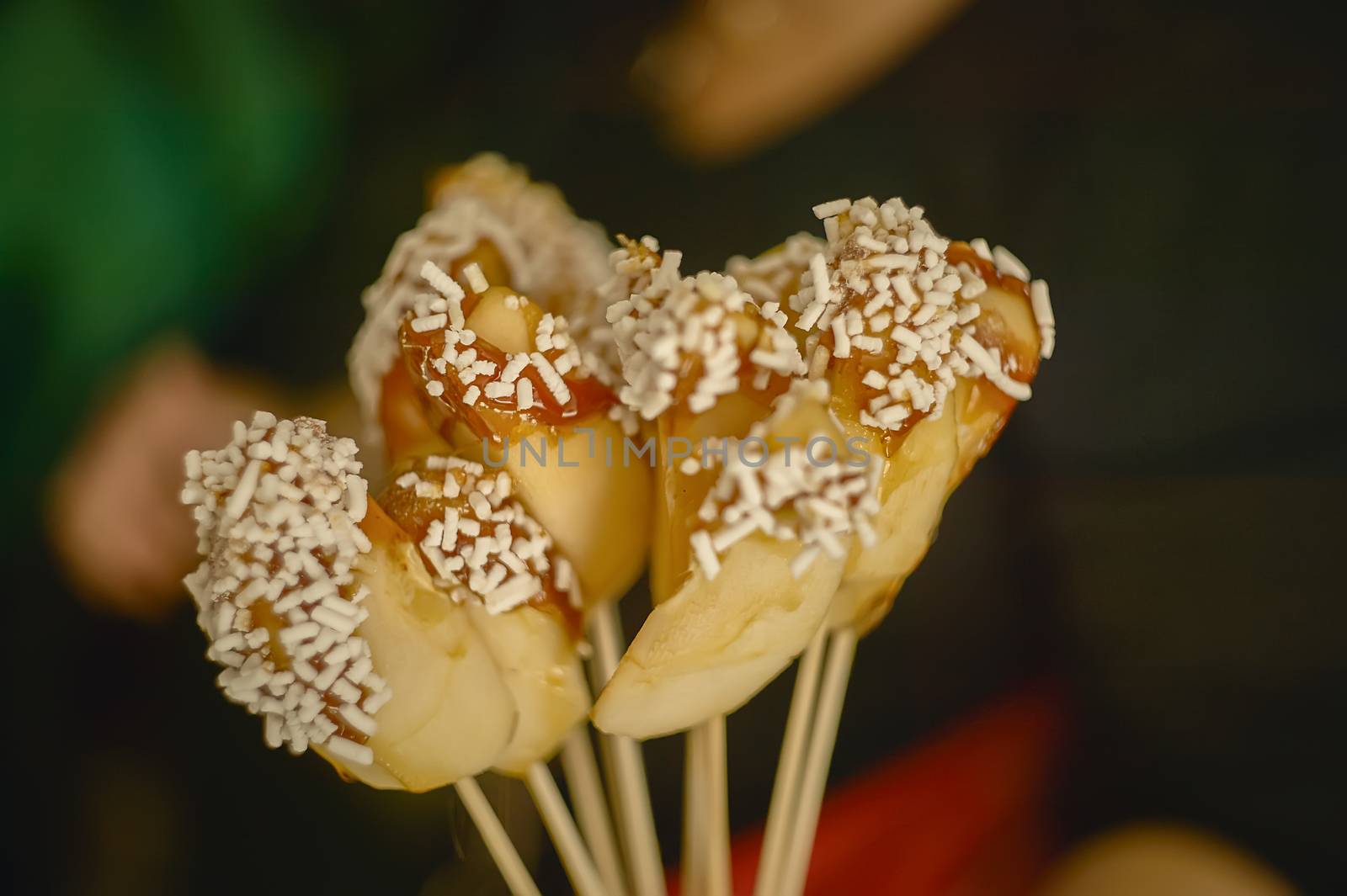 Slices of candy apples covered with sugar granules.