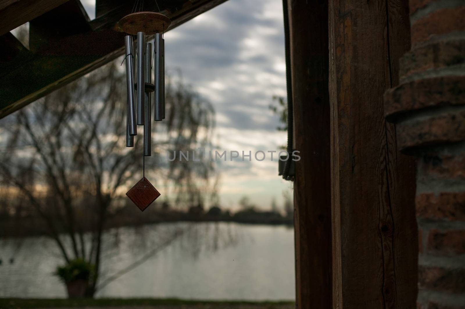 Metal hooks and wood hanging outside with a magnificent sunset behind