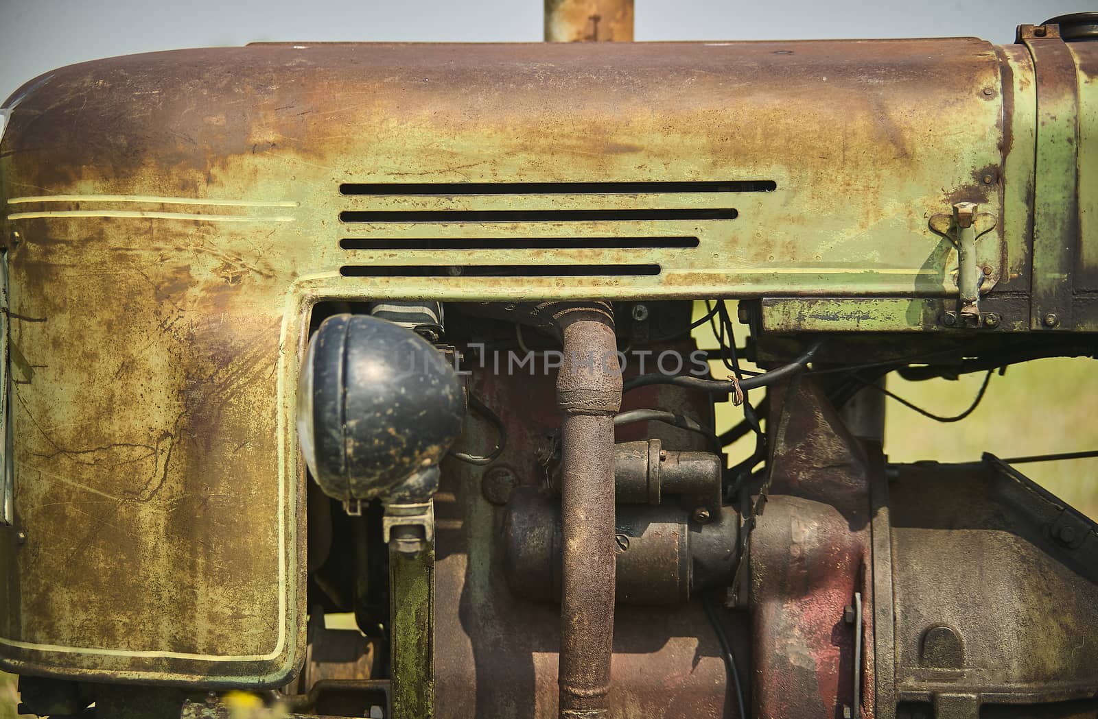 Old rusted engine belonging to a tractor 50 years ago.