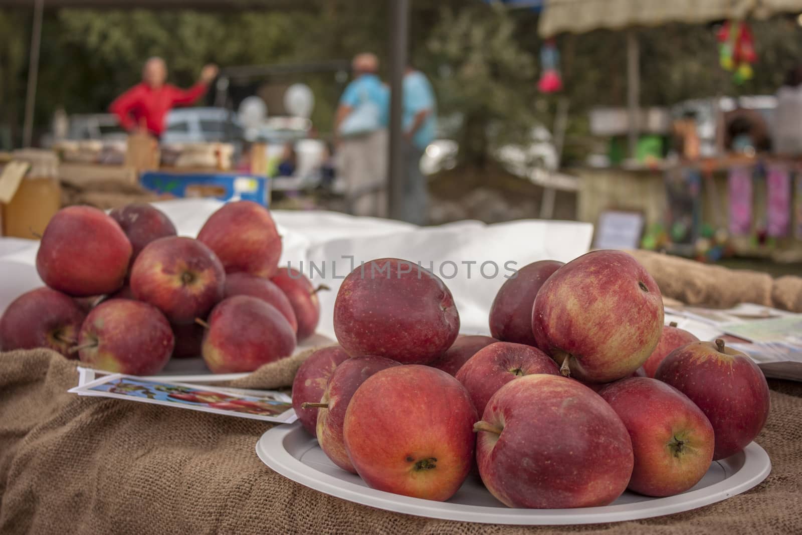 Two plates of red apples on top of a table at a traditional Italian banquet.