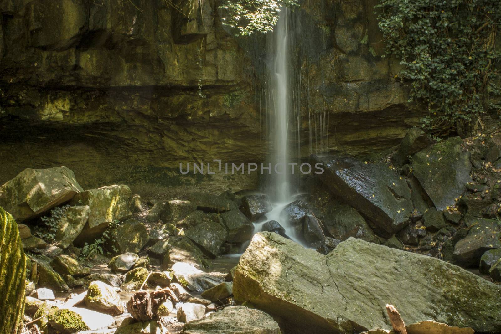 View of a waterfall (namely the Scivanoia waterfalls in Teolo Italy) in its summer period.