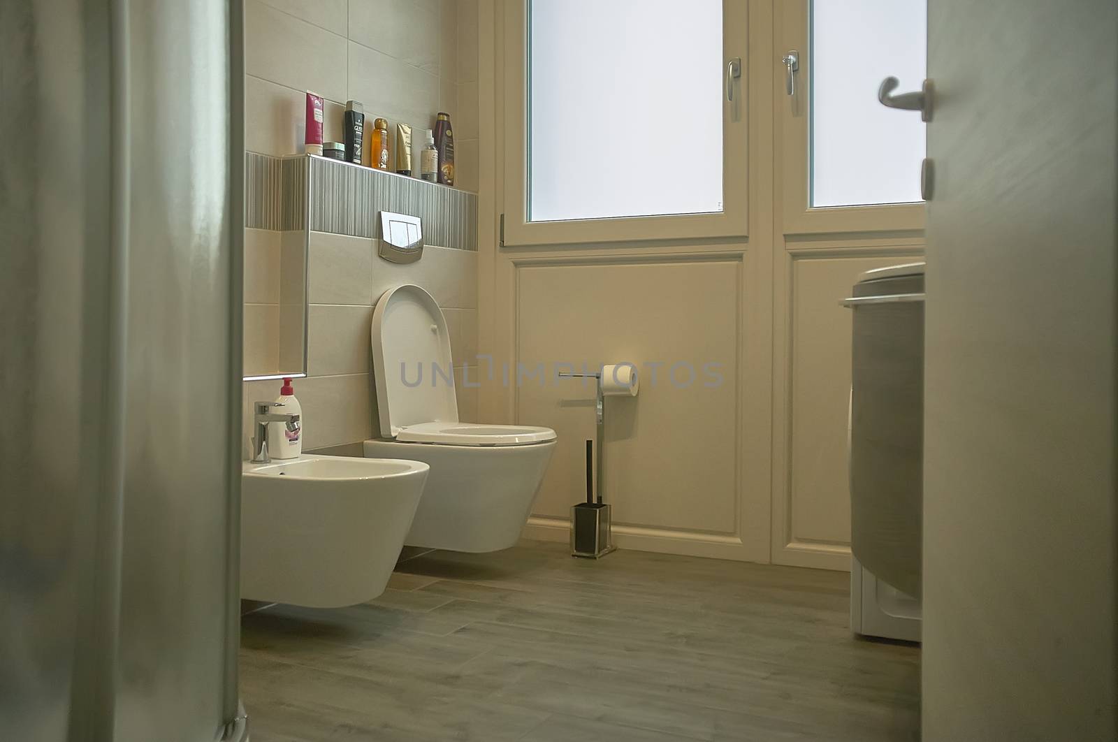 Interior of a modern style bathroom with minimal and essential furniture.