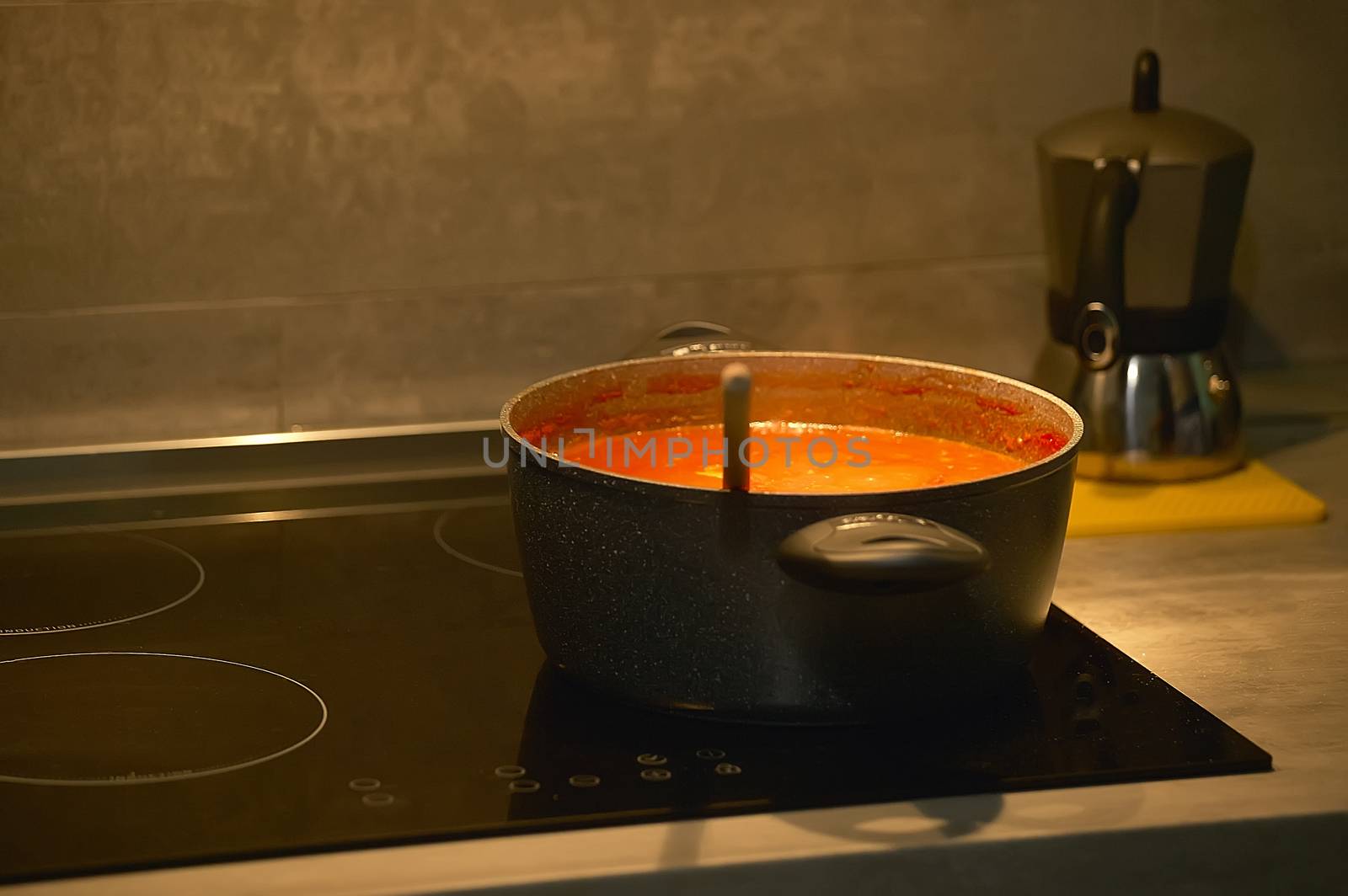 Saucepan that cooks in the kitchen above an induction cooker of the latest generation.