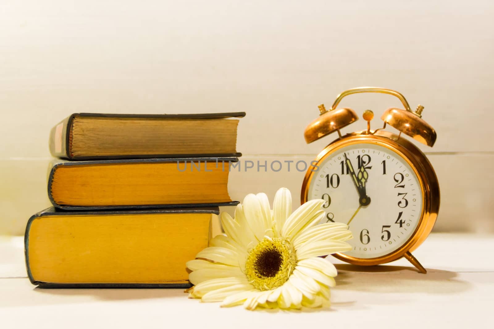 clock flowers and books concept of spring time and reading