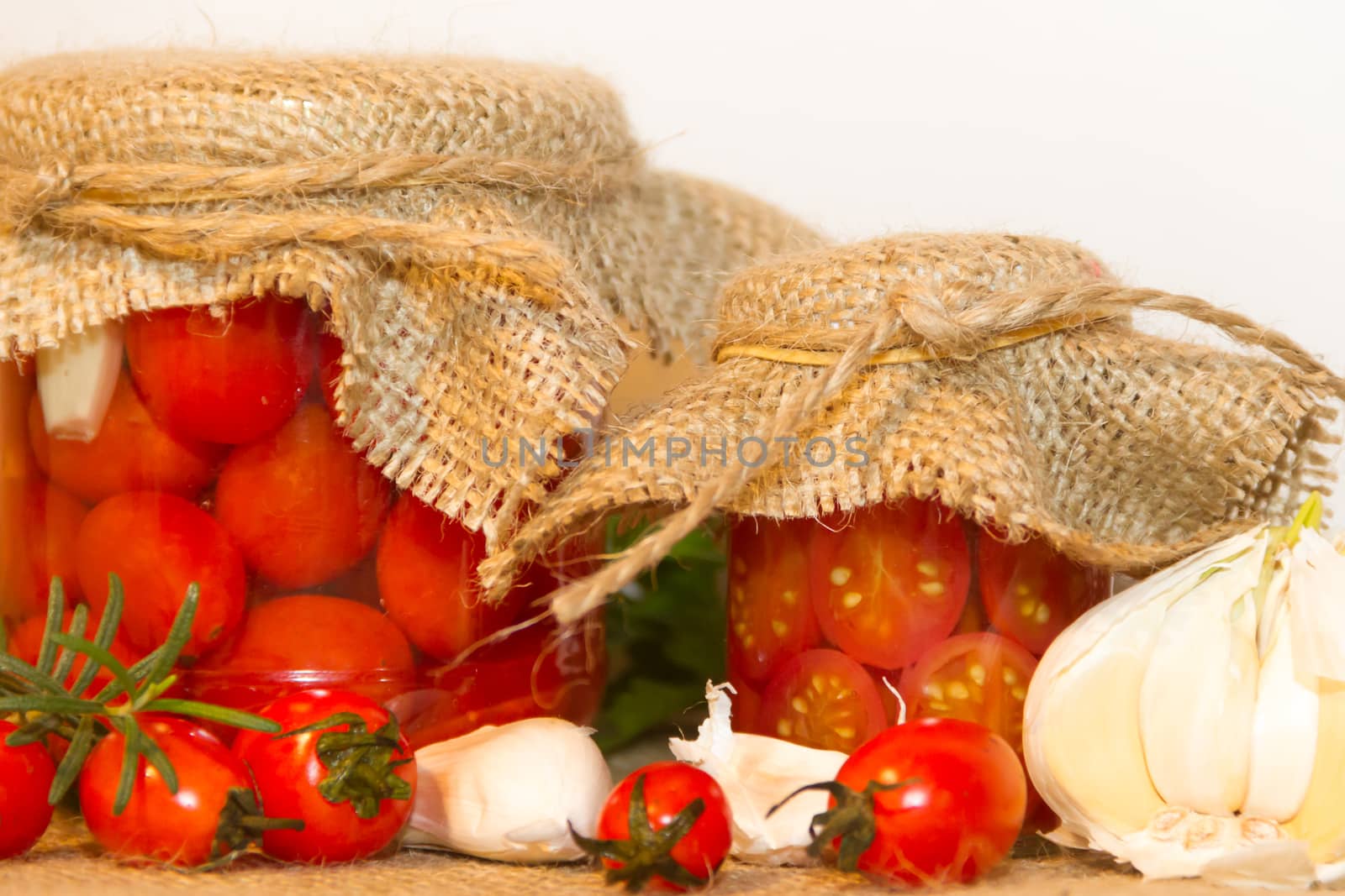 pickled cherry tomatoes in vinegar with garlic and spices