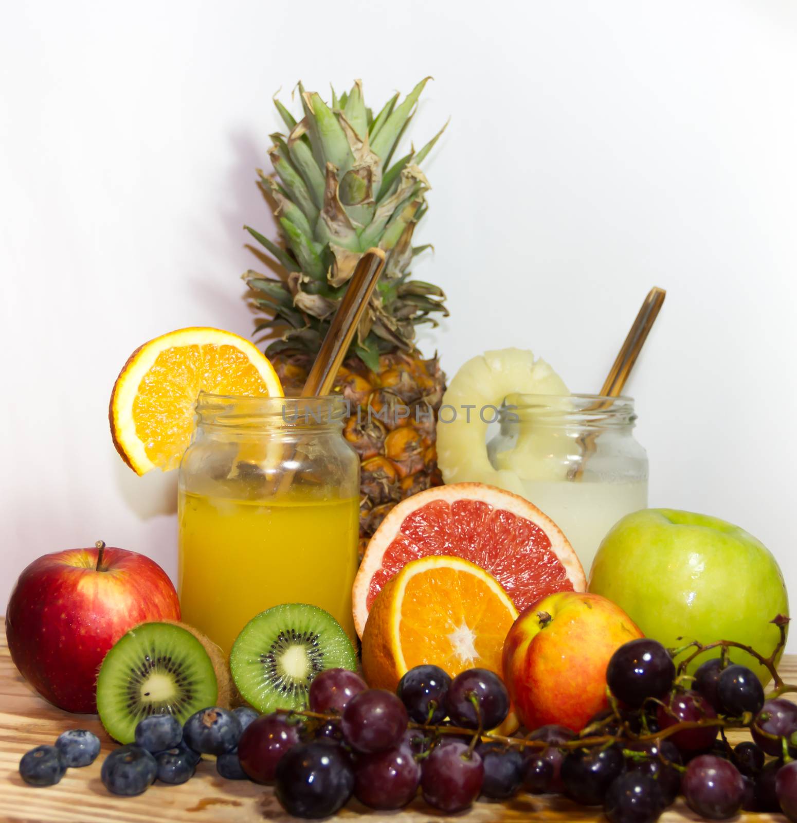 Juices smoothies and fresh pineapple and orange drinks with summer fruits by GabrielaBertolini
