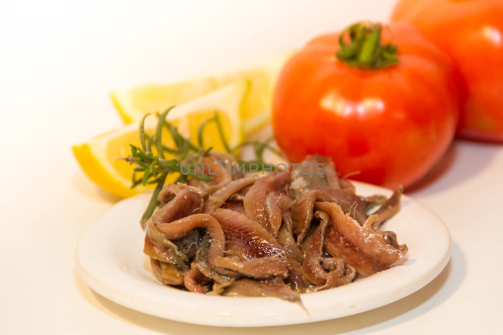 pickled anchovies with rosemary lemon vinegar and tomatoes