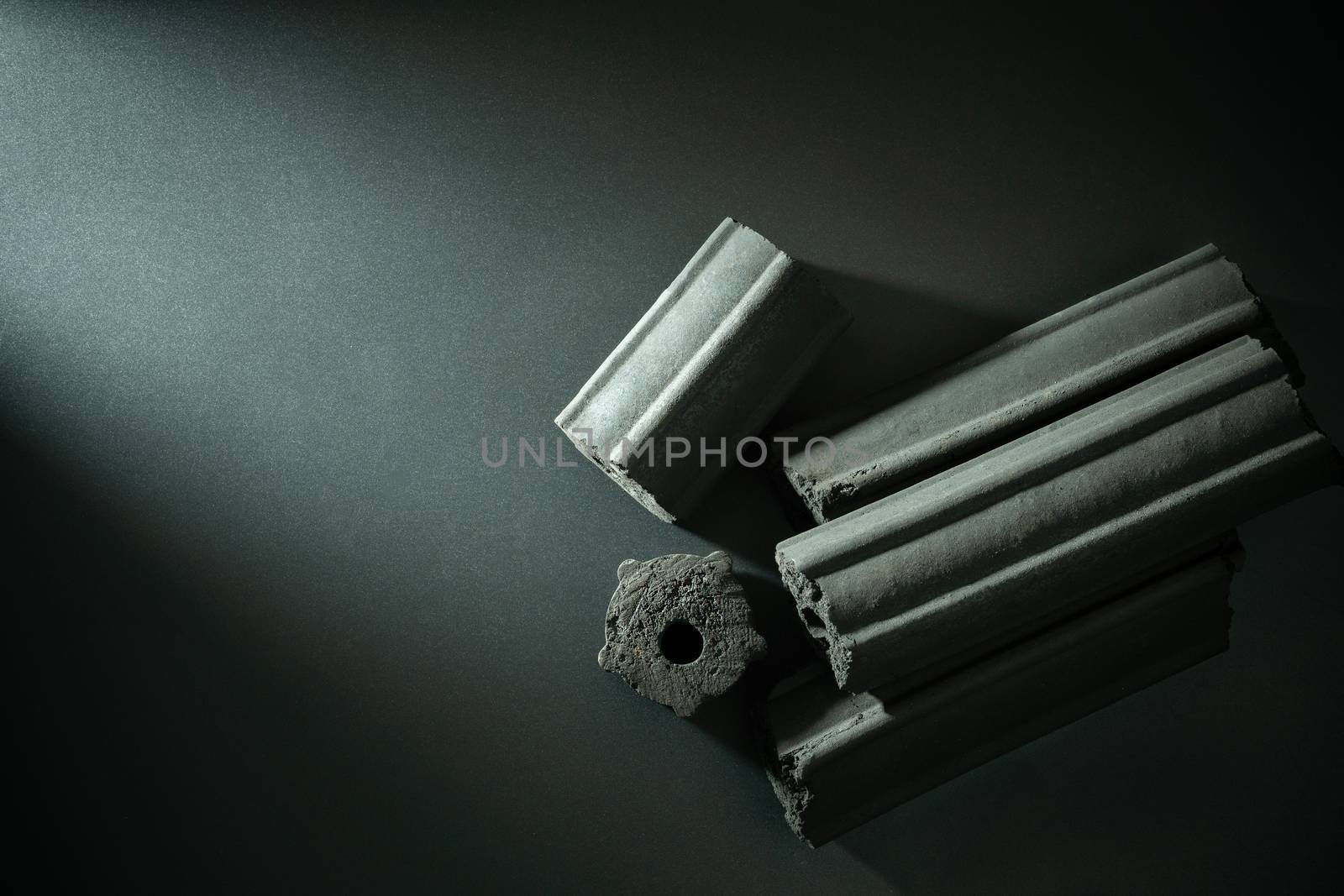 Carbon activated. Bamboo charcoal compressed in to stick on darkness background. Has the ability to absorb toxins in the human body. Concept of health care. Top view and copy space.