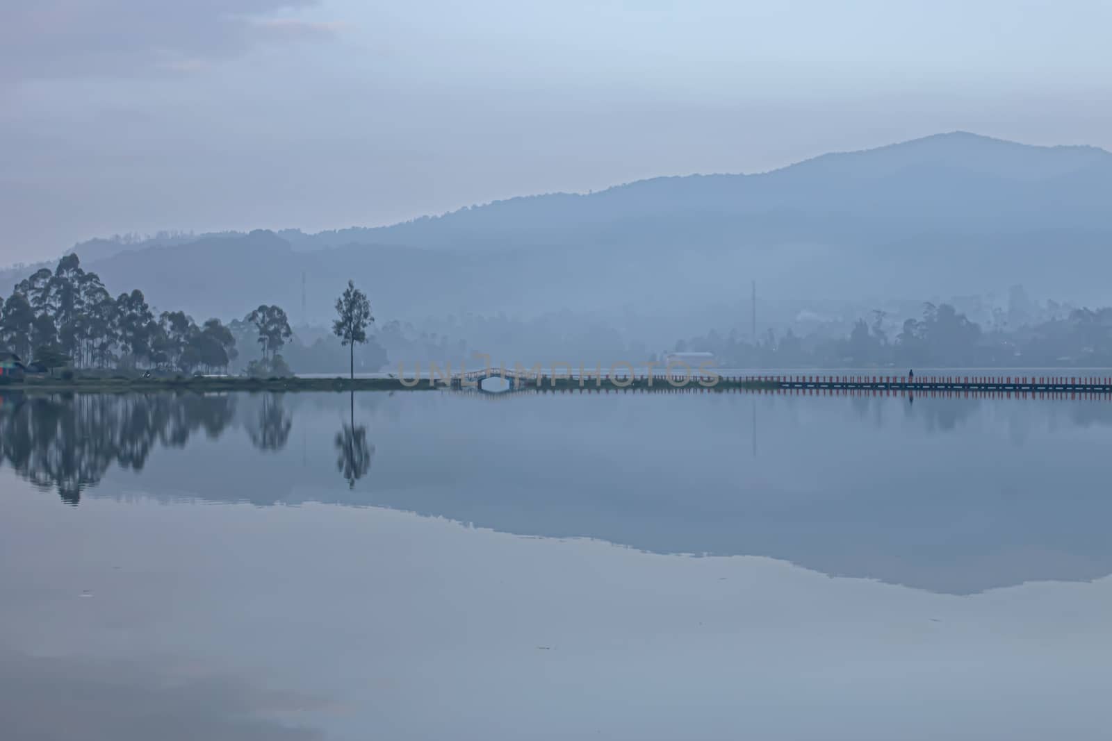 Reflection mountain, bridge and tree on a lake Cileunca Pangalengan - Indonesia