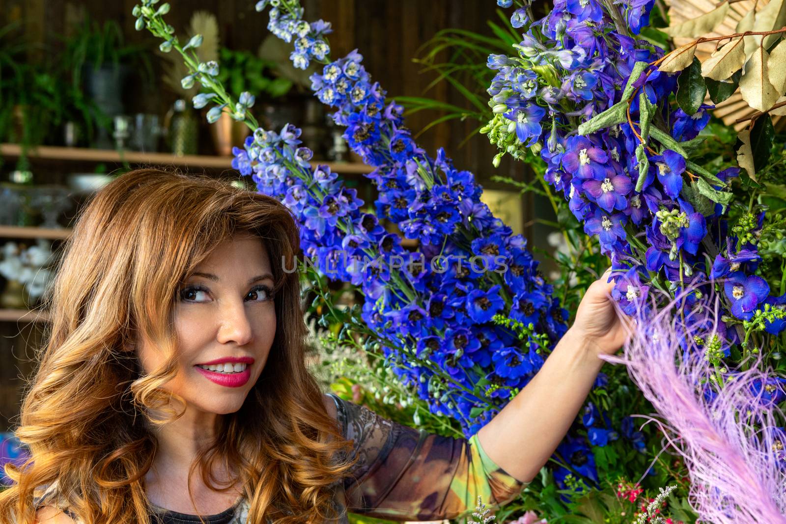 Florist shop owner or a customer standing outside of shop with the floral displays