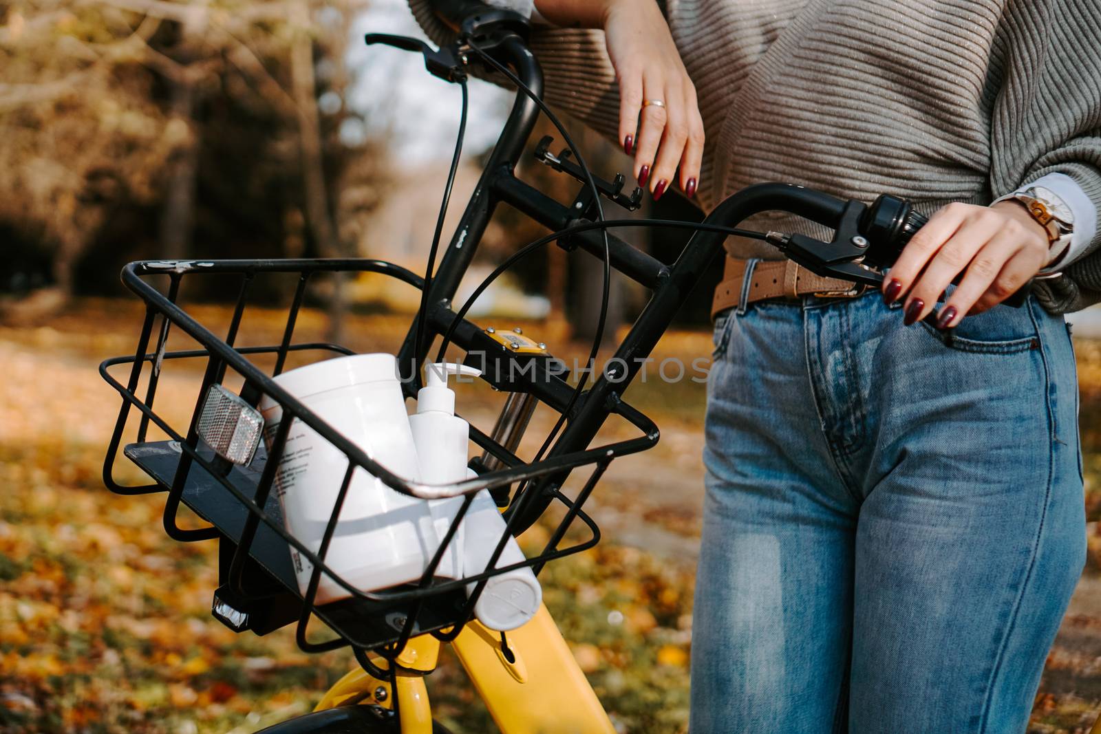 Bicycle basket with cosmetic jars. The concept of sport, outdoor recreation and healthy lifestyle. Self-care in the fall