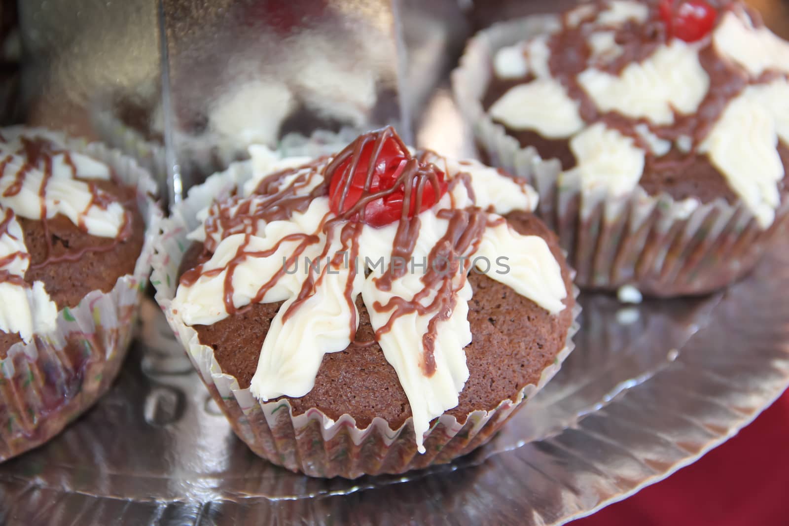 delicious cupcakes and muffins with chocolate and cherries