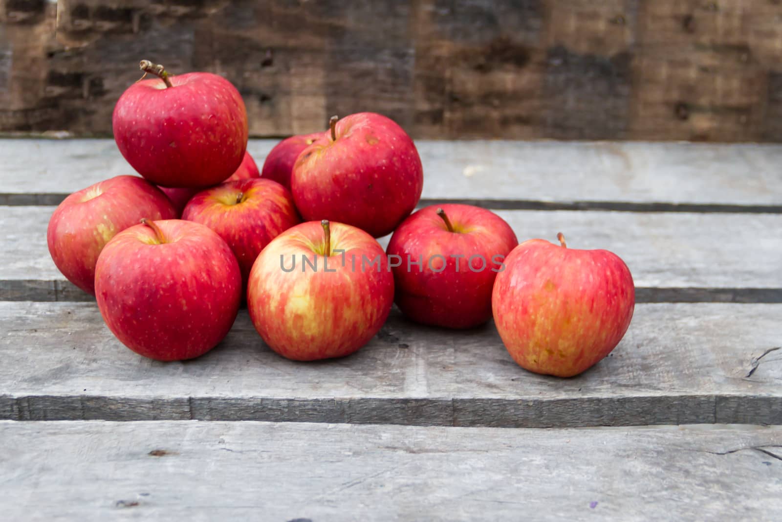 red apples on rustic wooden background