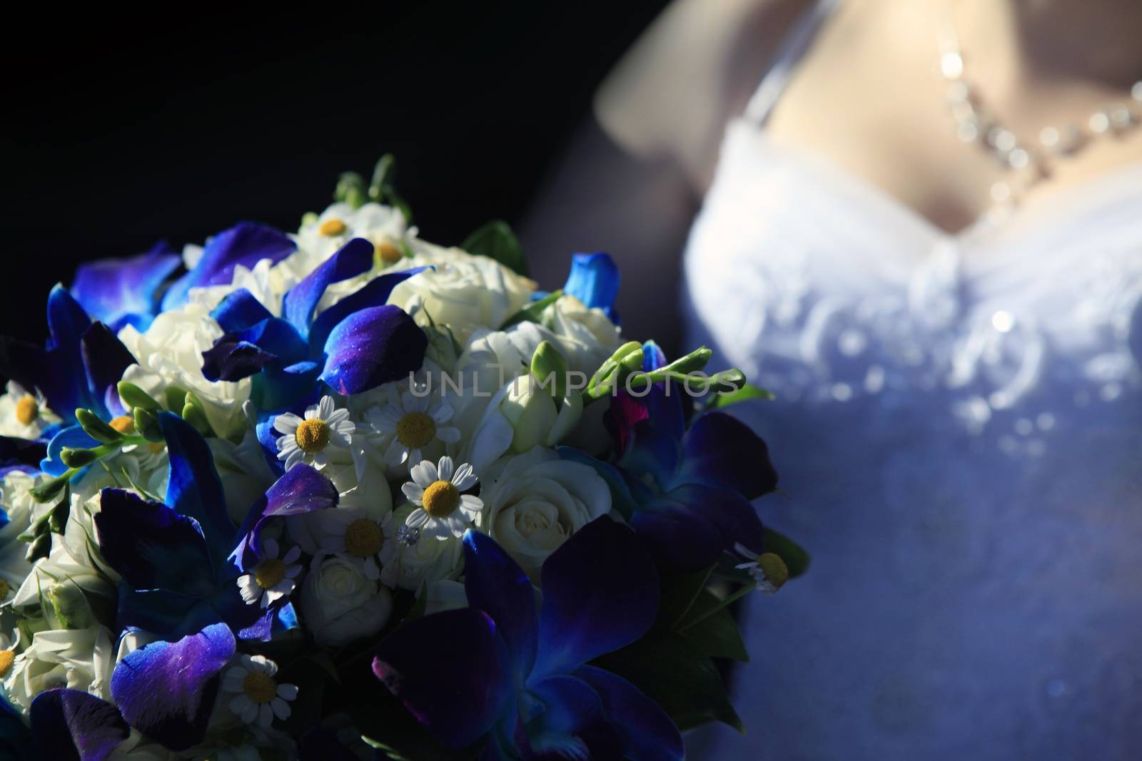 The bride holds a wedding bouquet