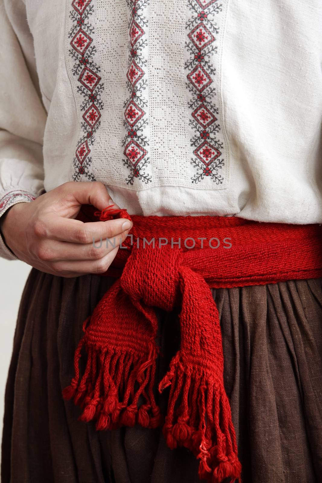 Cossack in an embroidered shirt with a red belt by friday