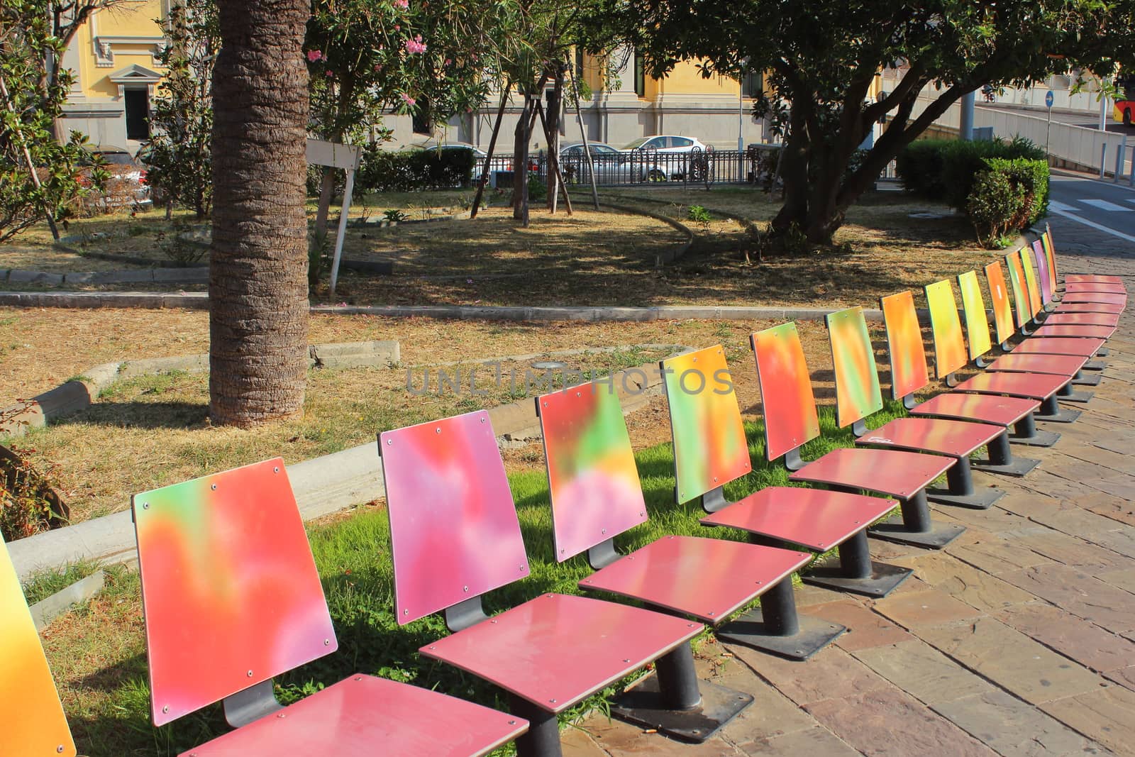 set of colorful benches during a beautiful day by giuseppe_capellupo