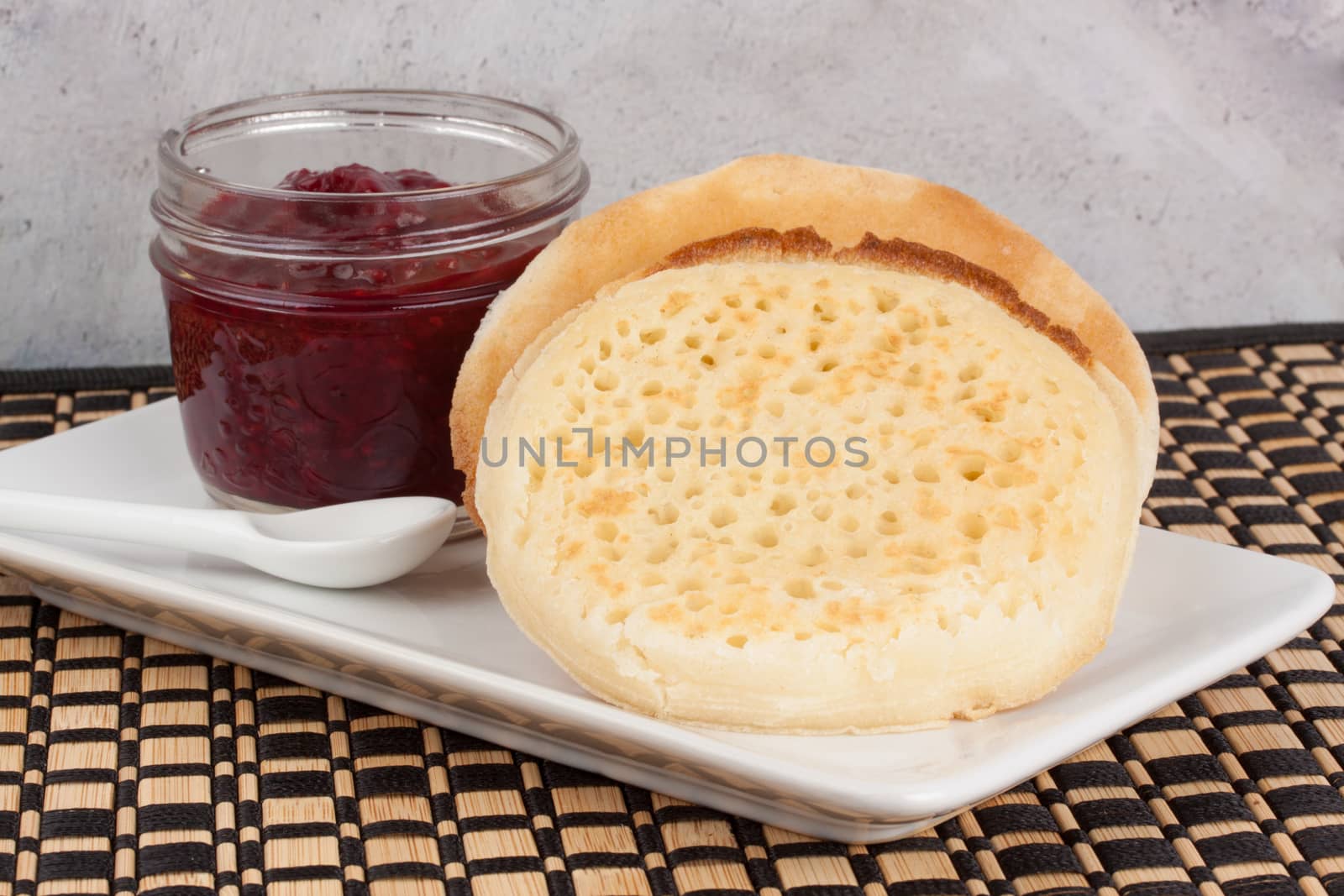 Crumpets and raspberry jam in a reusable glass jar by lanalanglois