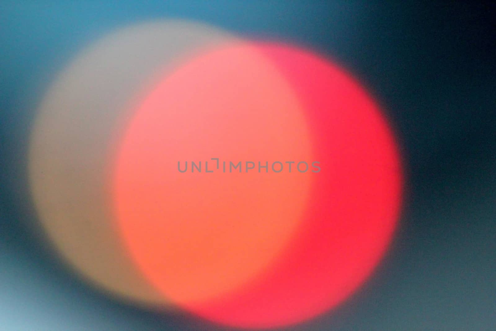 Defocused lights, red lens flare. Abstract blured background.