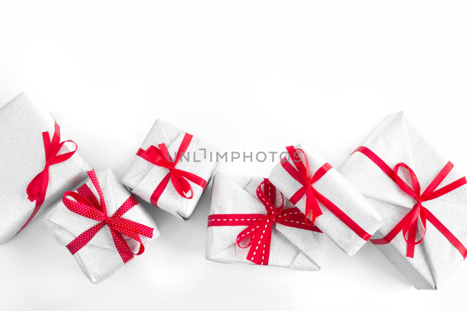 Border frame design element background of silver glitter gifts with red ribbon bow decoration isolated on white background top view flat lay composition with copy space for text