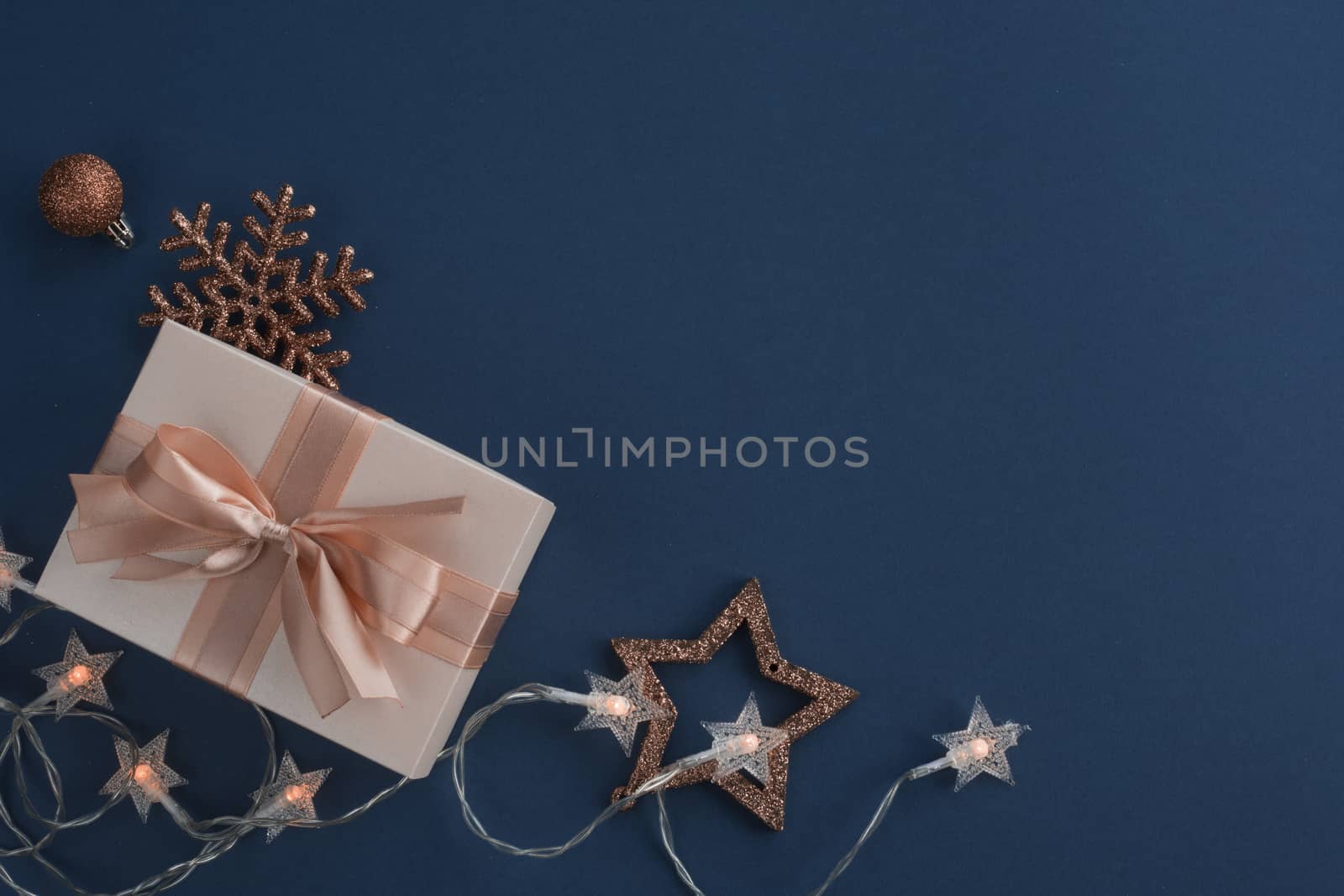 Unusual Christmas gift on stylish dark blue background with copy space for text , top view flat lay design composition