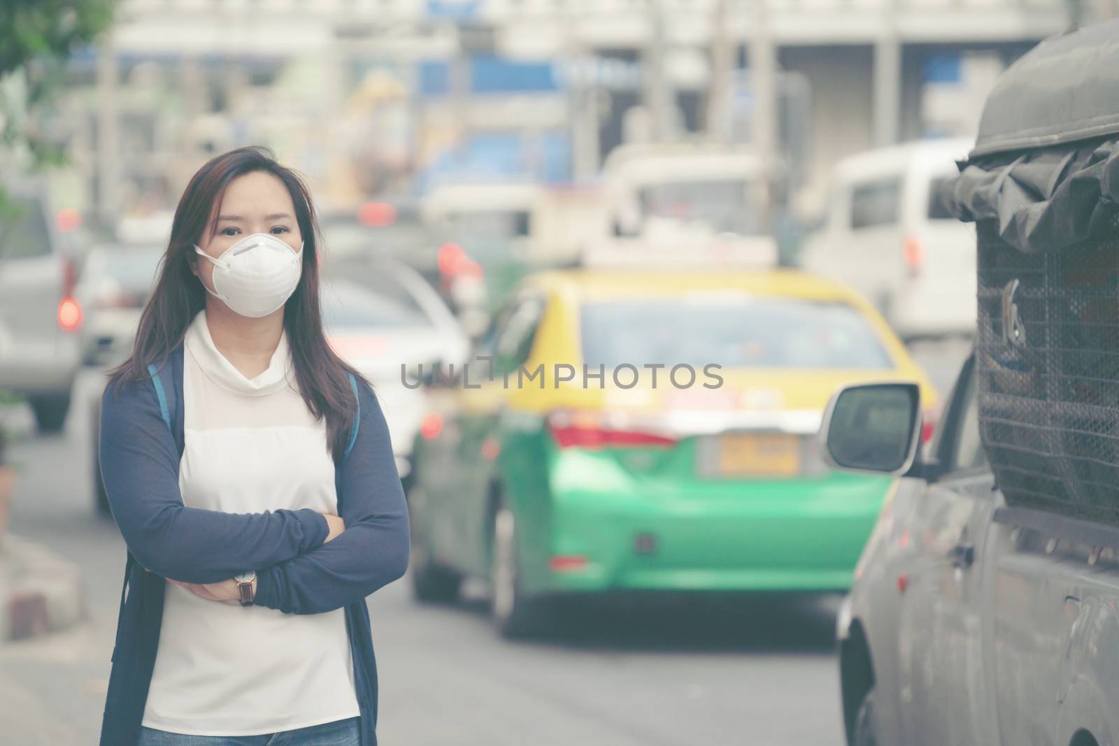 woman wearing protective mask in the city street by anankkml