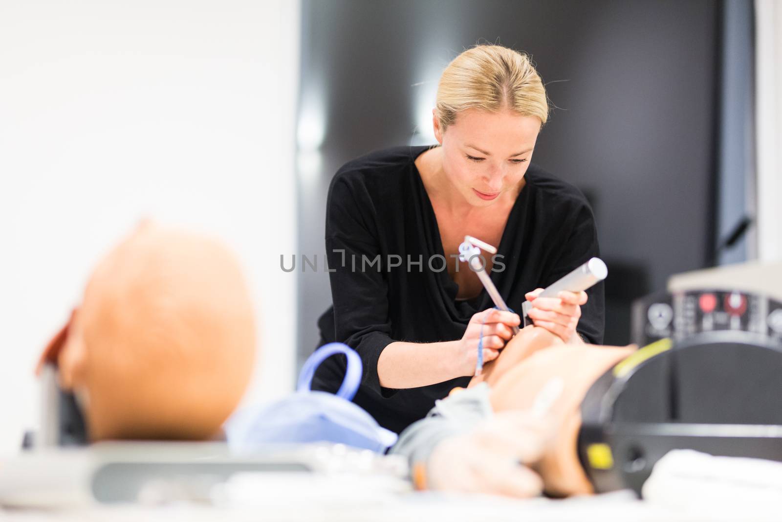 Medical doctor specialist expert displaying method of patient intubation technique on hands on medical education training and workshop.