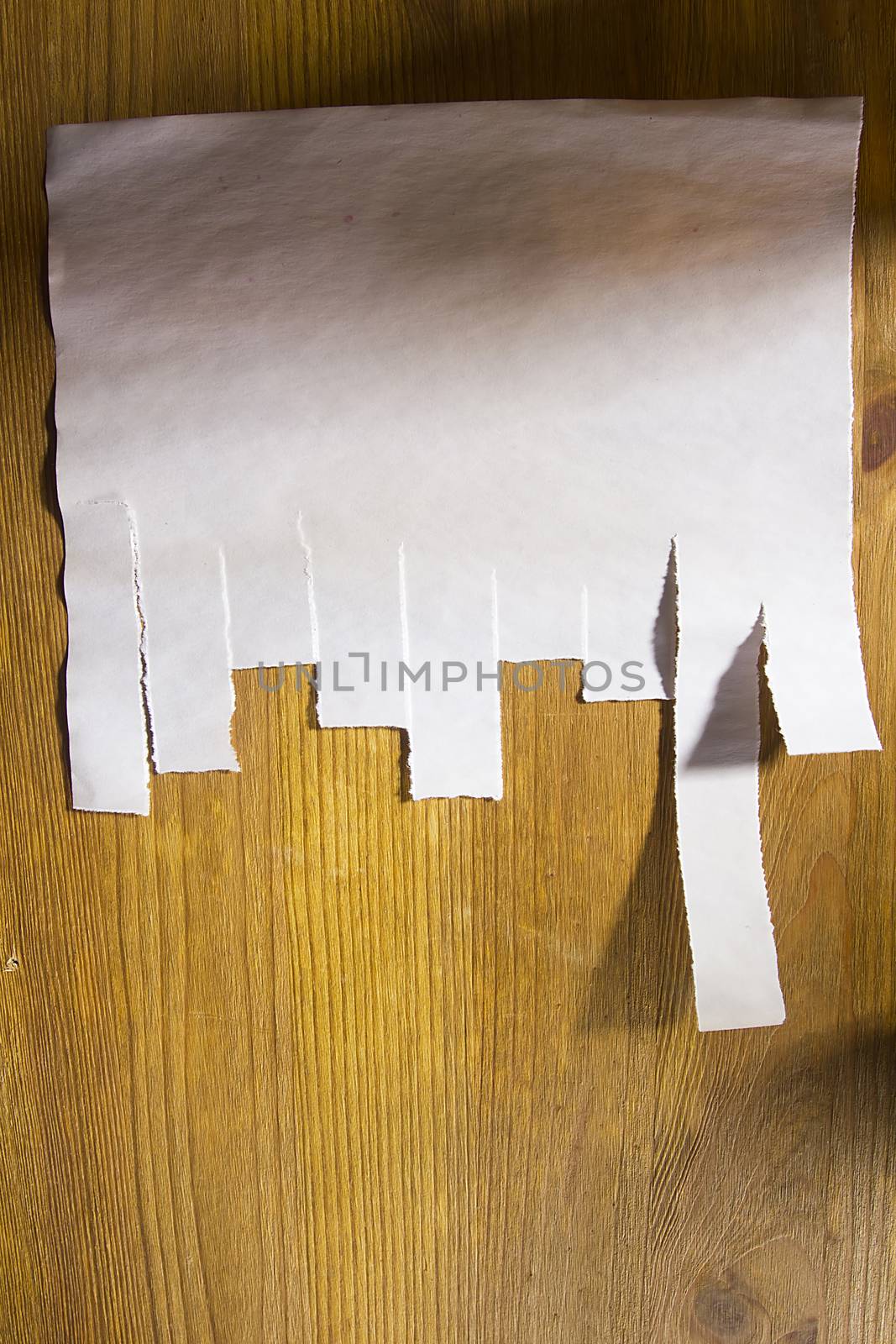Paper for announcement with tear-off strip on a wooden wall