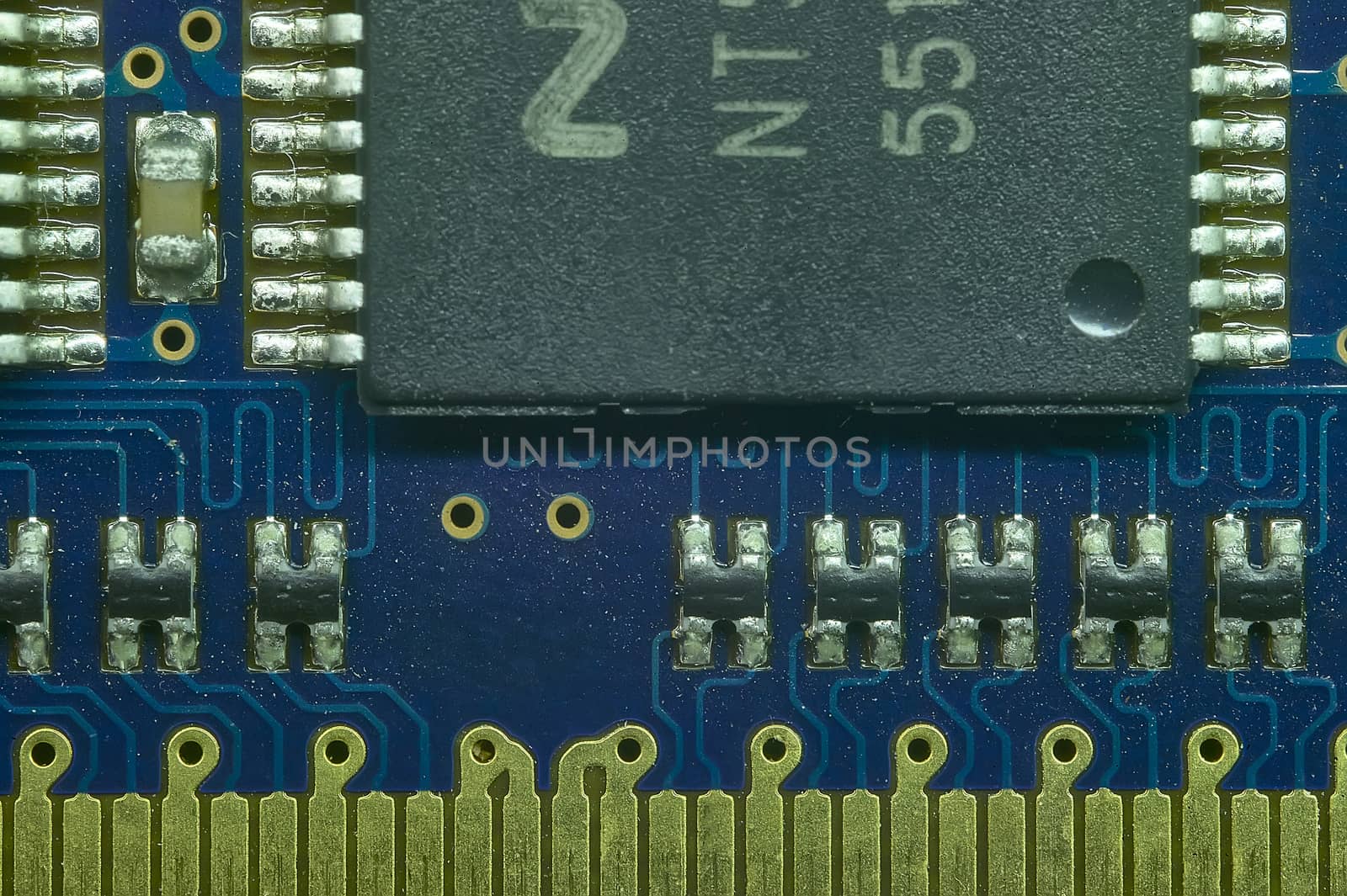 Welding of the pins of a microprocessor to the electronic board in macro shot with very high definition.