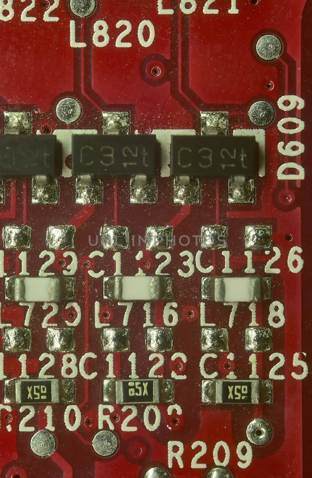 Detail of a detail of some electronic components such as resistors and capacitors mounted and welded on its electronic board.
