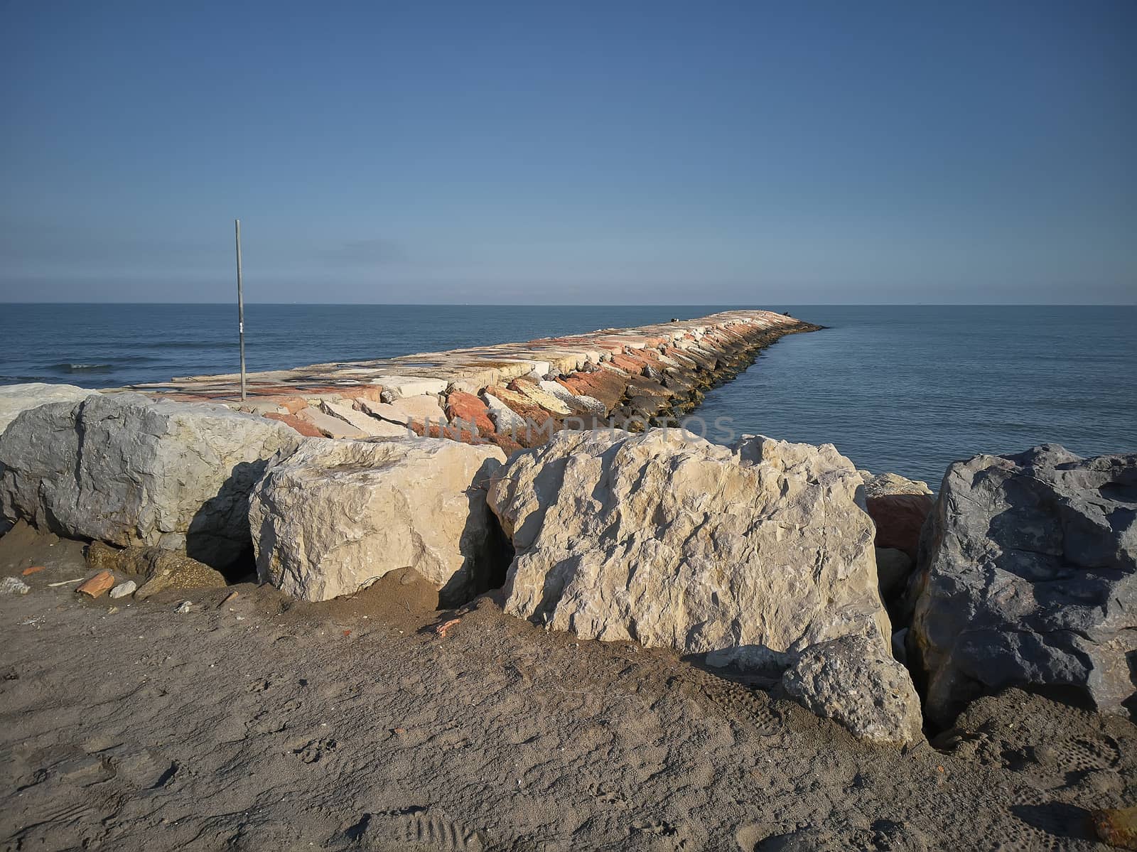 Wide angle view of a cliff on the sea at Rosolina Mare In Italy