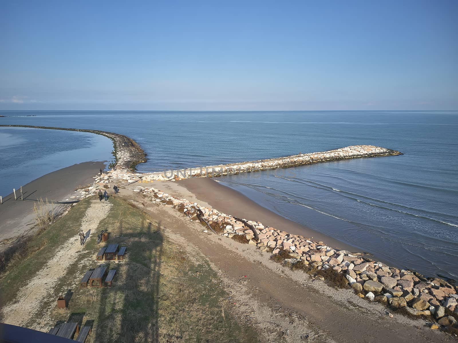 Aerial view of a system of dams of pebbles created to protect the beach of Rosolina in Italy; an example of how natural and artificial coexist in creating a unique landscape.