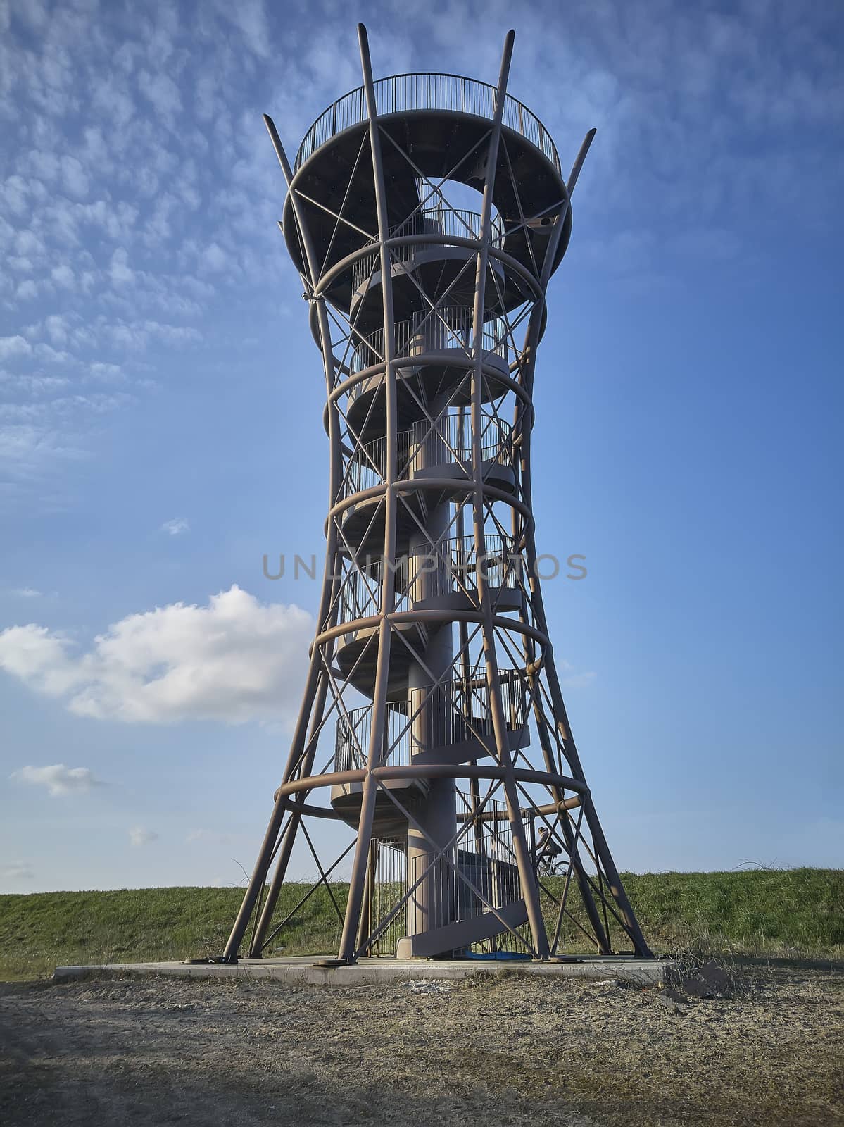 Panoramic tower in metal with spiral staircase surrounded by greenery and nature to observe the surrounding landscape from above.