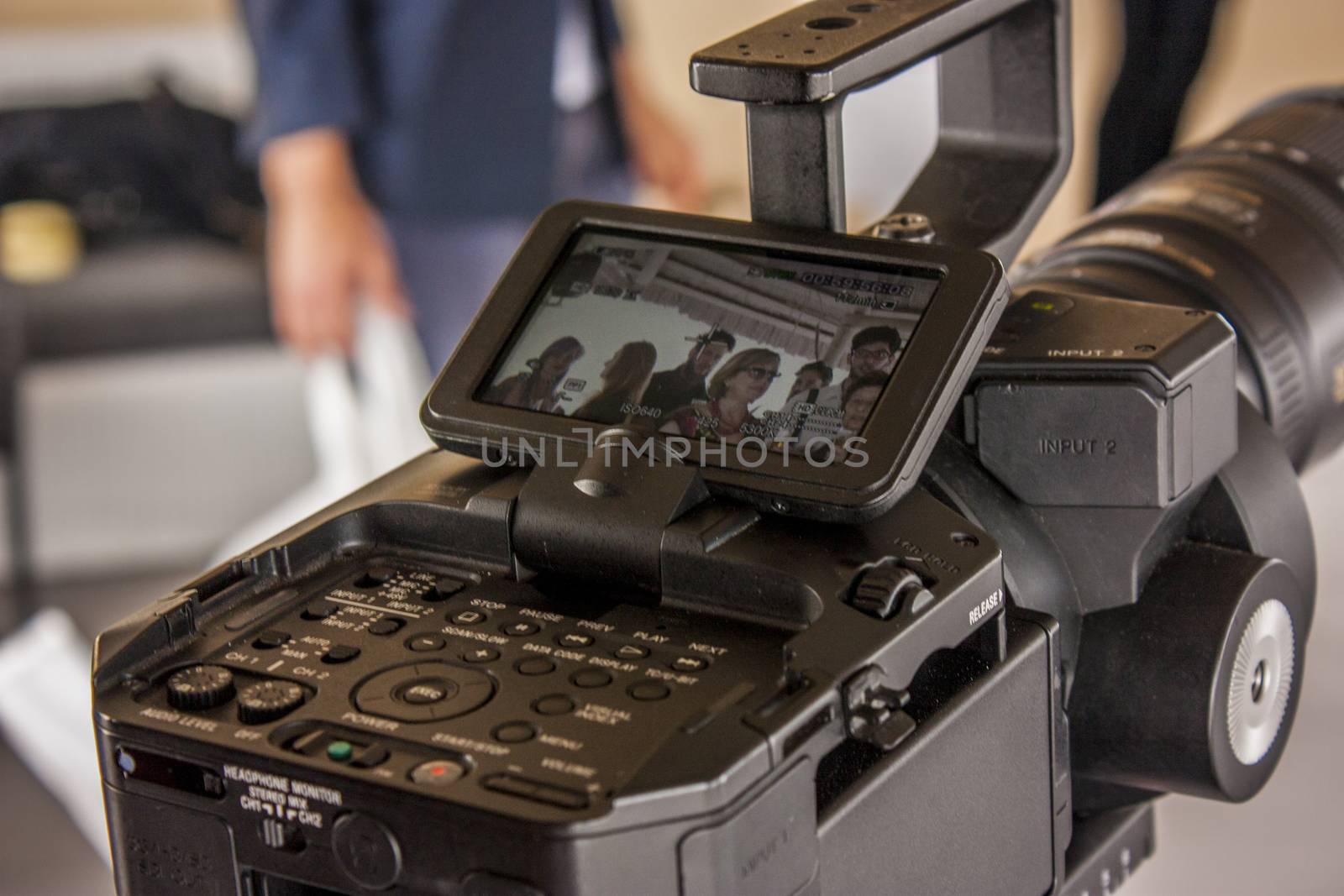 Backstage photos to a detail of a digital camera while he is filming a movie scene.