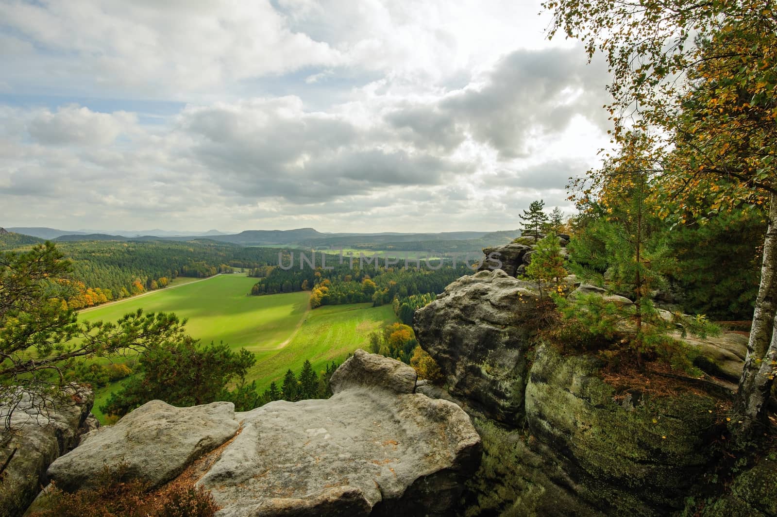 Autumn colorful landscape with forests, hills, sun and sky