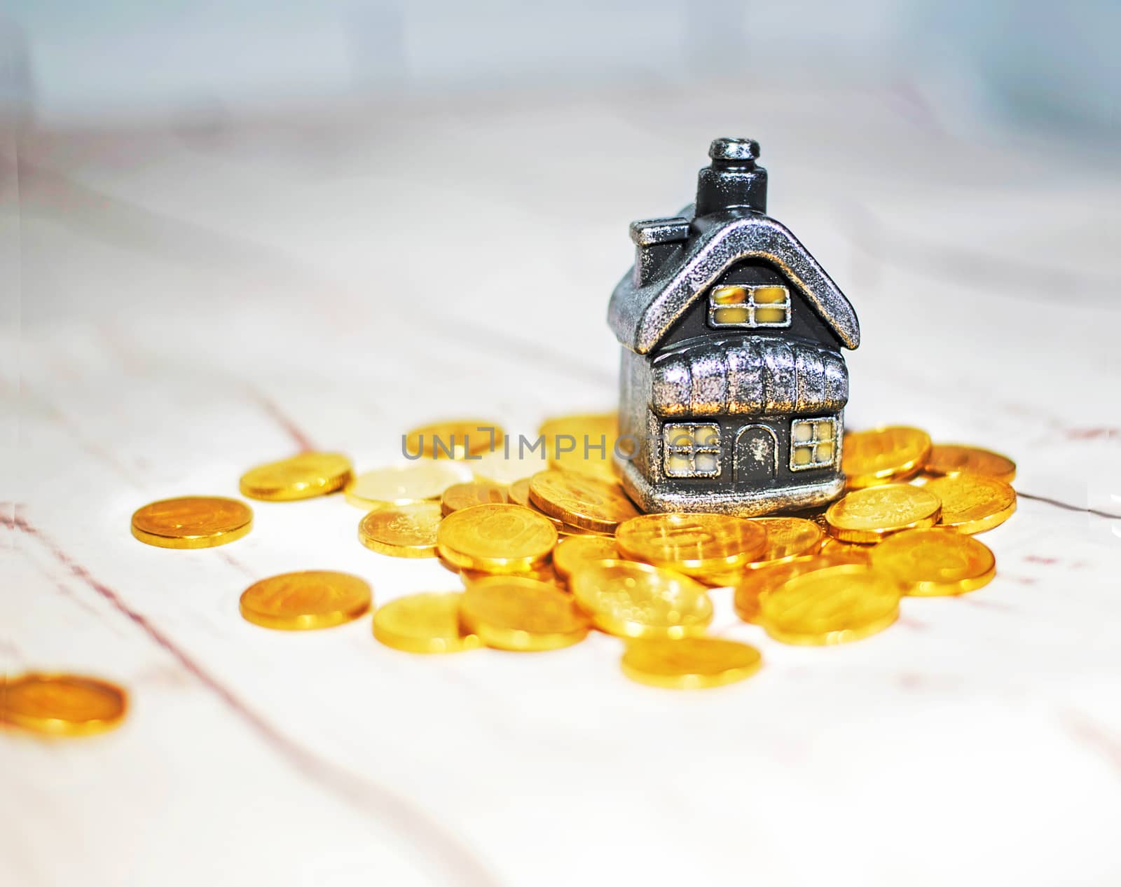 The house stands on a pile of coins, the concept of cash savings, loans..