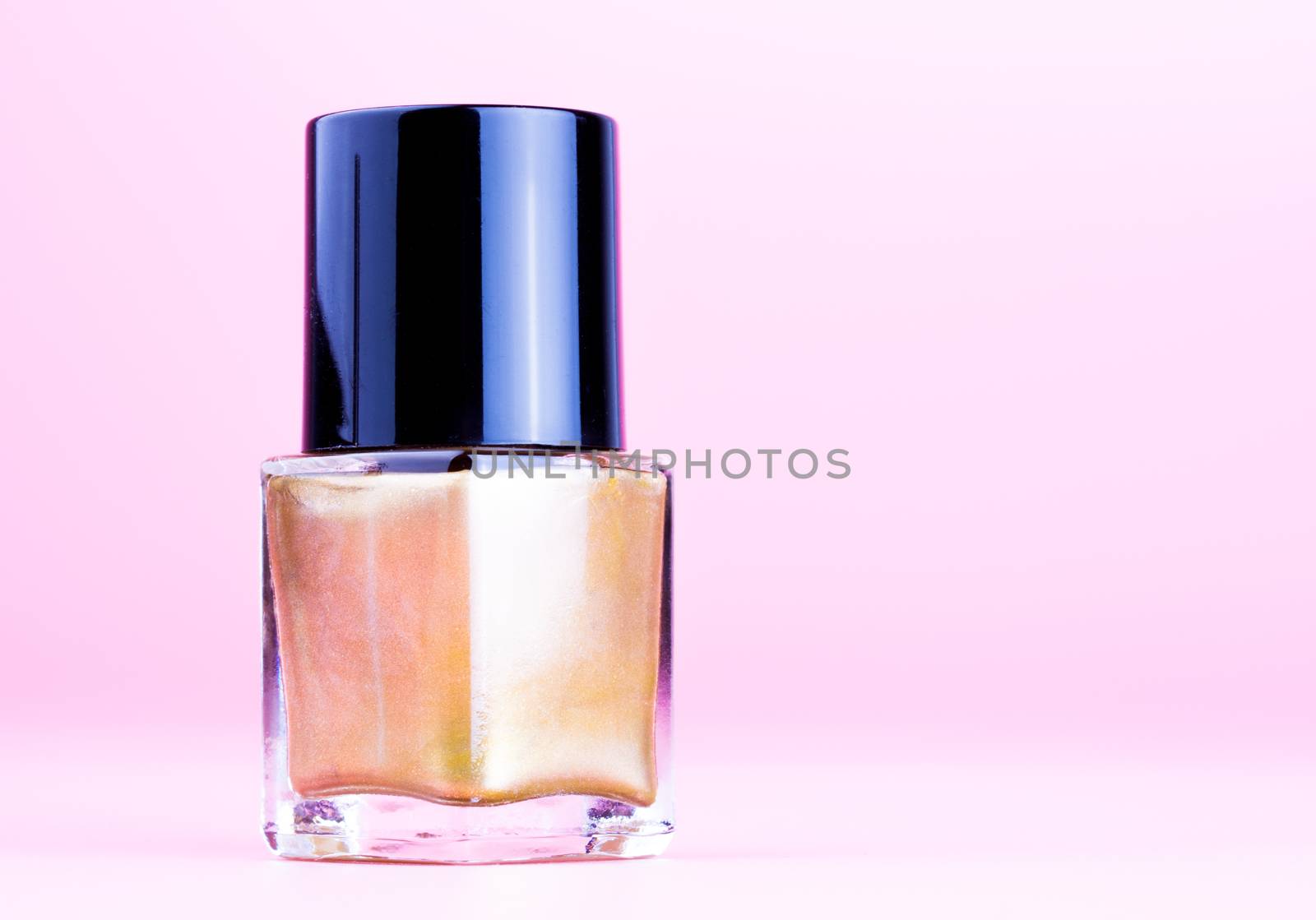 Bottle of gold nail polish by lanalanglois