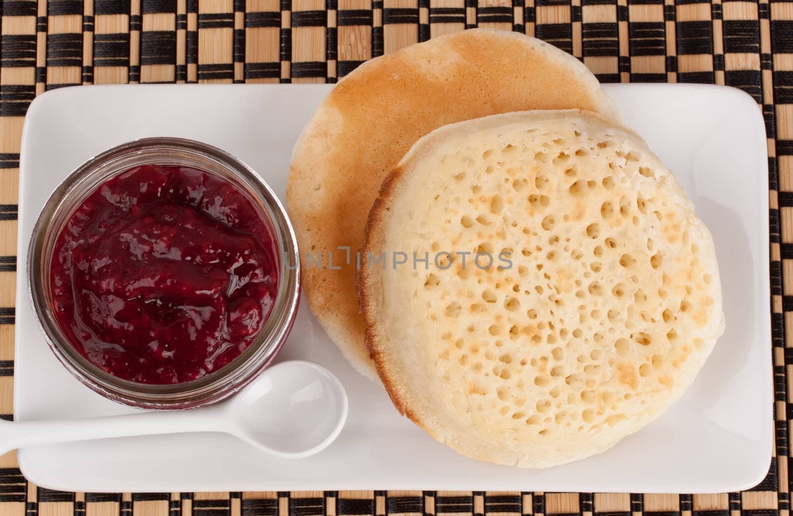 Crumpets and raspberry jam in a reusable glass jar by lanalanglois