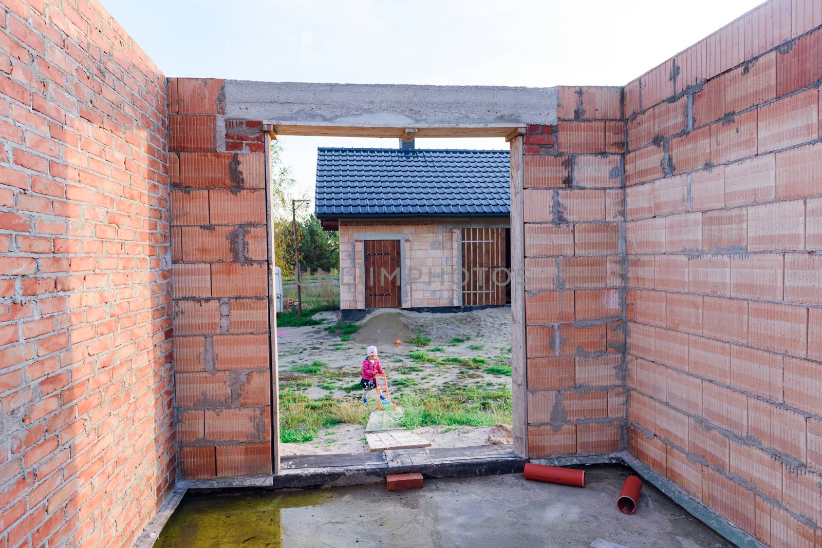 Interior of a Unfinished Red Brick House Walls under Construction without Roofing.