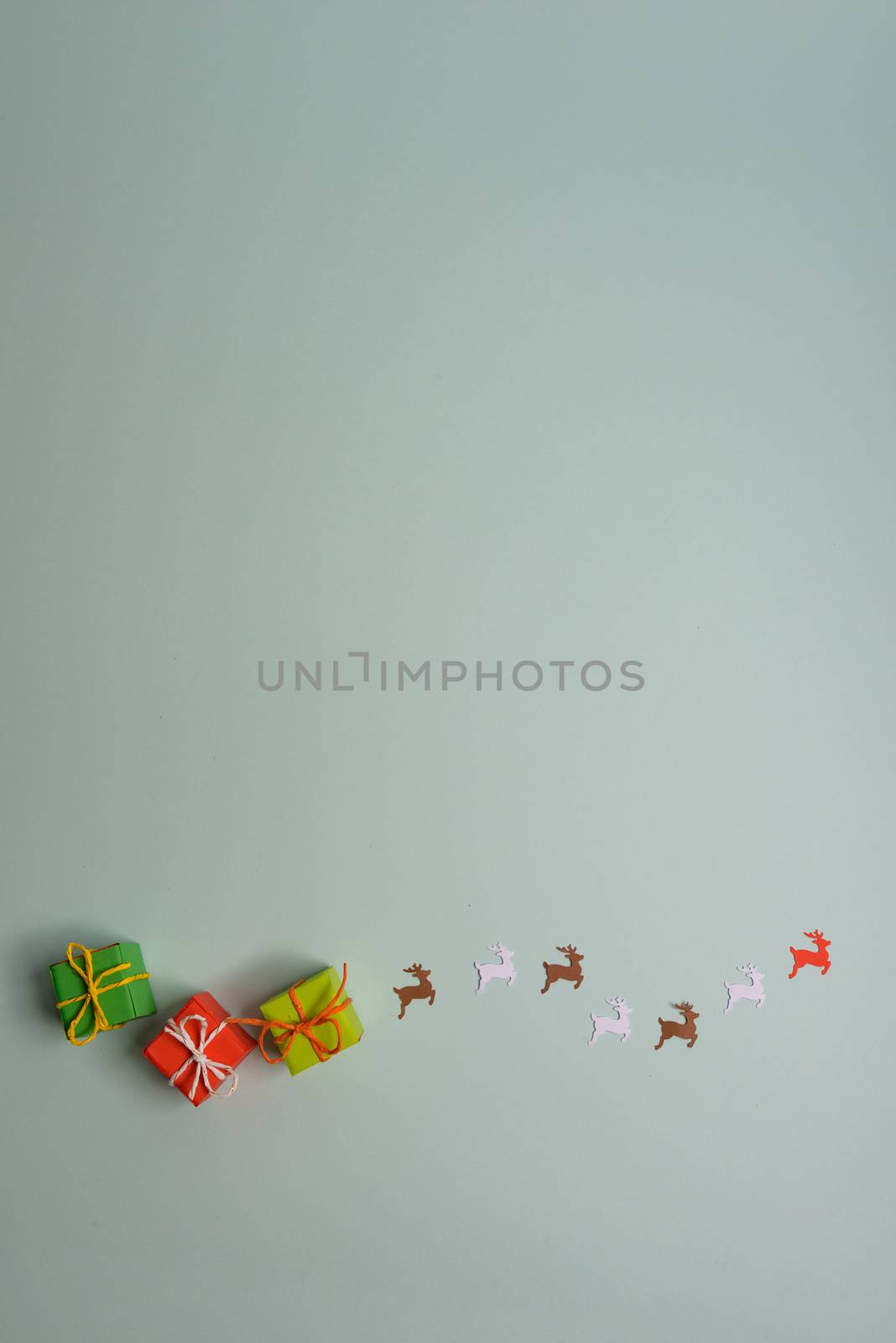 christmas presents nicely decorated with bows and feathers. view from above. Reindeers.