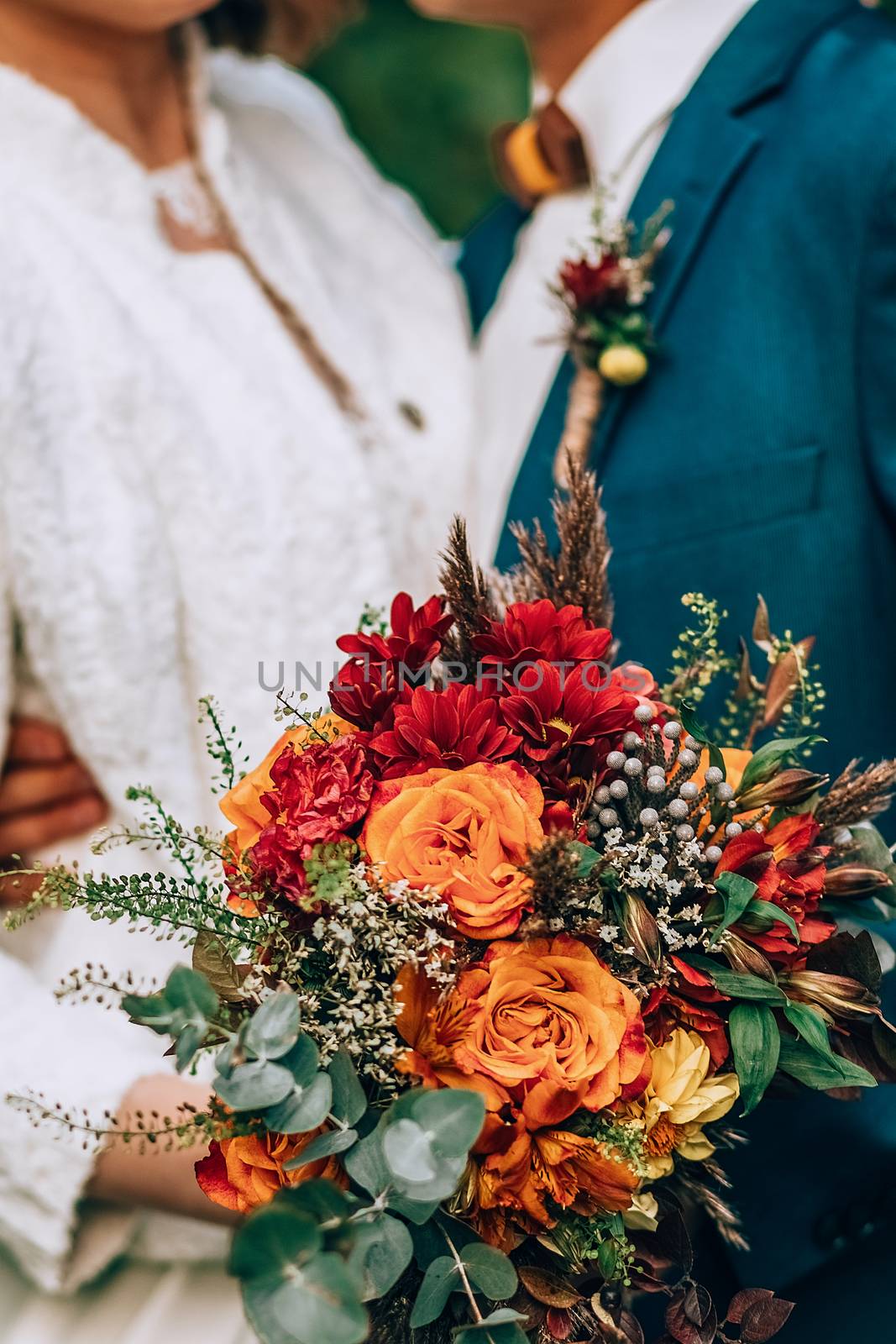 Amazing wedding bouquet with vibrant flowers and green and brown herbs by 3KStudio